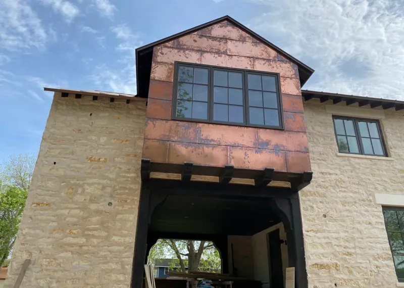 Copper metal panel facade on a stone building for Roof Repair in Toccoa