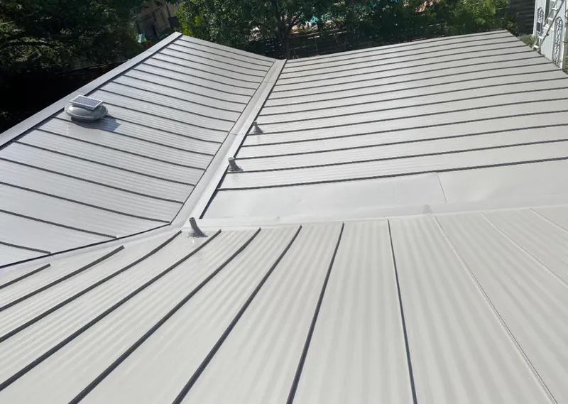 Solar attic fan installed on a metal roof for Roof Ventilation in Toccoa